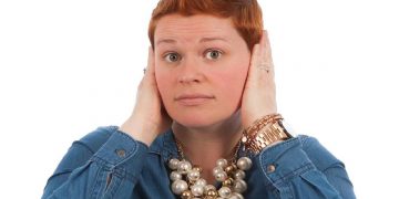 Una donna con le mani premute sulle orecchie