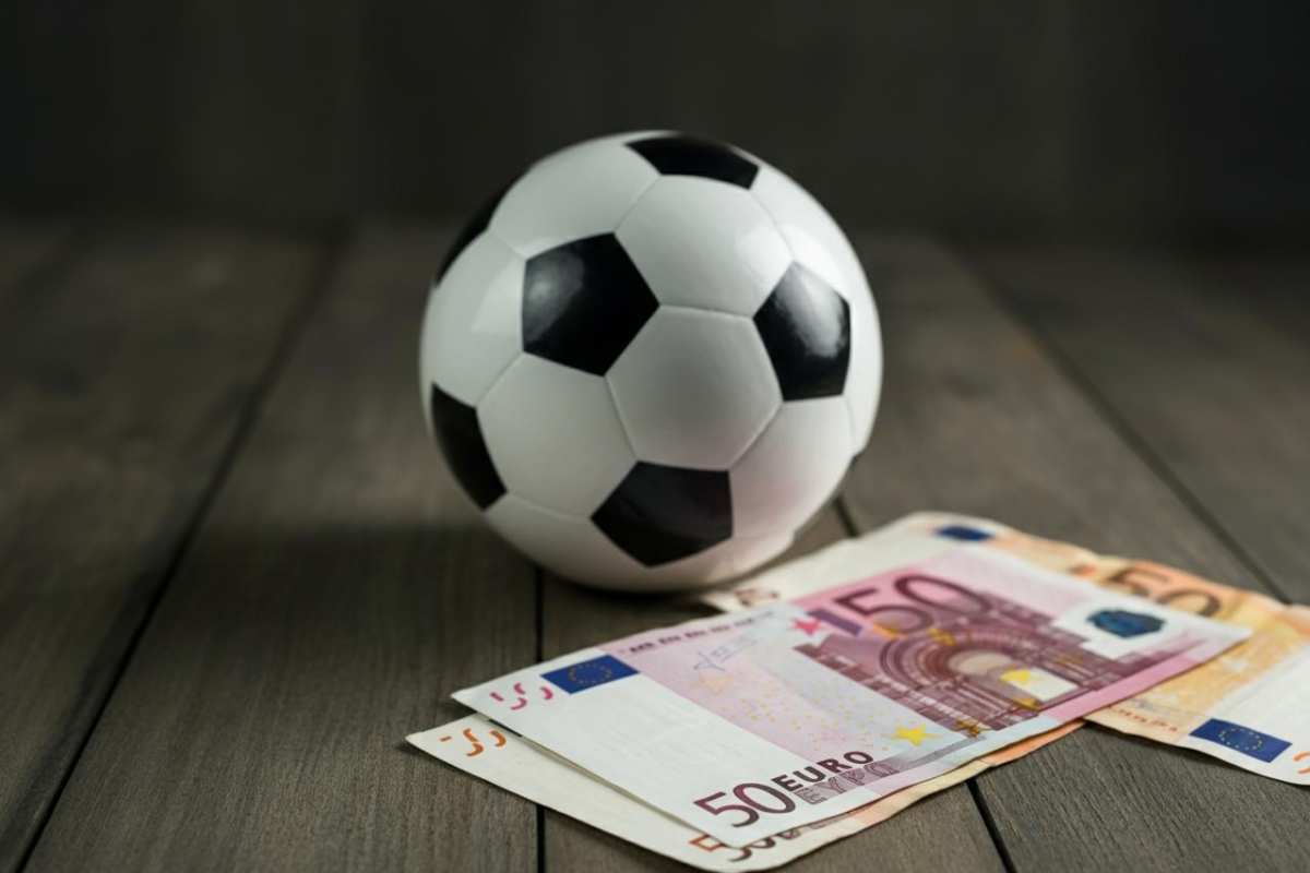 Un pallone da calcio vicino a delle banconote