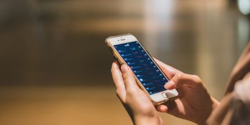 Una donna con in mano uno smartphone