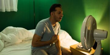 Un uomo che non riesce a dormire a causa delle temperature notturne elevate