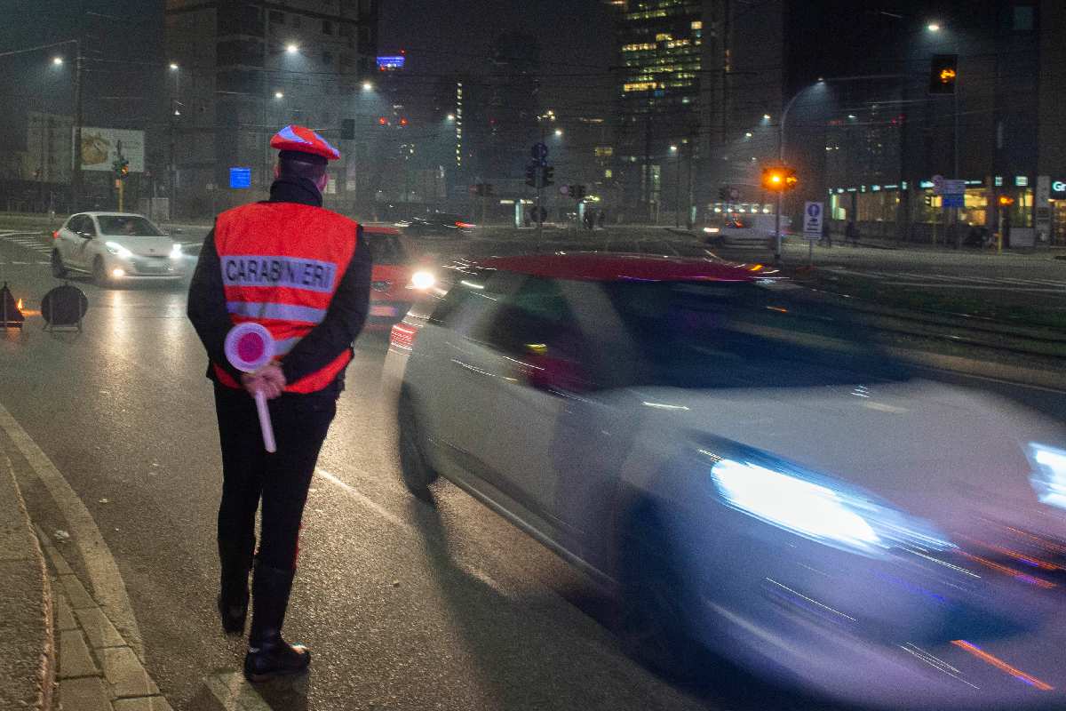 Un carabiniere a un posto di blocco che mette le multe per gli autovelox