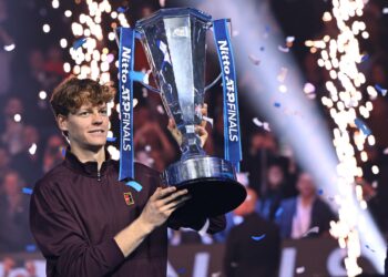 Italy's Jannik Sinner lifts the trophy after winning over Spain's Carlos Alcaraz