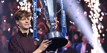 Italy's Jannik Sinner lifts the trophy after winning over Spain's Carlos Alcaraz