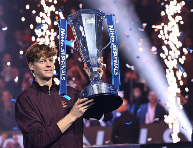 Italy's Jannik Sinner lifts the trophy after winning over Spain's Carlos Alcaraz