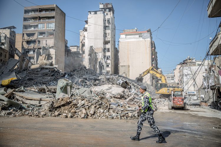 March 19, 2026, Beirut, Lebanon A policeman walks past the remains of a building in Bachoura, which was hit by an Israeli airstrike