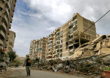 March 25, 2026, Beirut, Lebanon A resident of Beirut's southern suburb carrying bags of Manakish