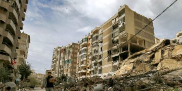 March 25, 2026, Beirut, Lebanon A resident of Beirut's southern suburb carrying bags of Manakish