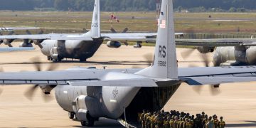 Paratroopers entering a US Air Force C-130 Hercules transport plane on Eindhoven airbase