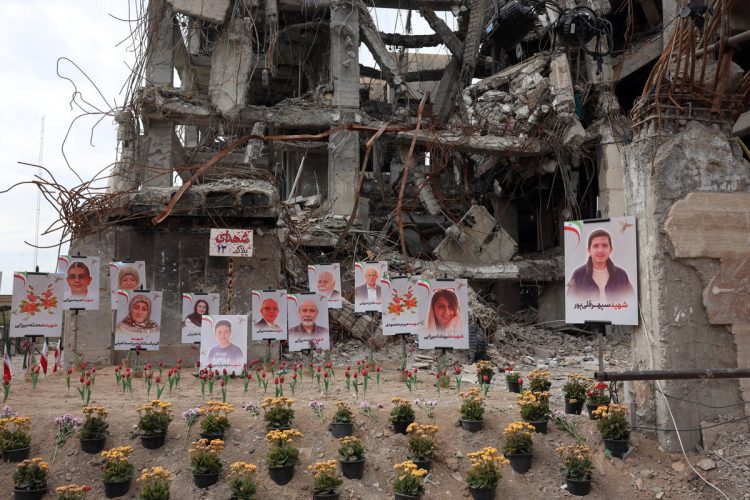 Photographs of airstrike victims displayed outside damaged building in Tehran