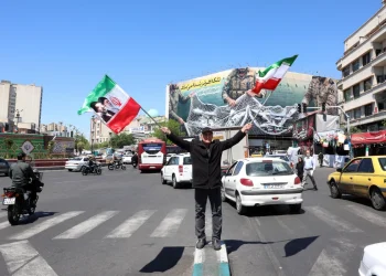 An Iranian man waves Irans national flags at the Enghelab square in Tehran, Iran, 22 April 2026