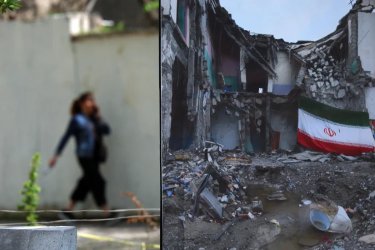 An Iranian woman walks next to an image depicting war damage in a park in Tehran, Iran, 21 April 2026