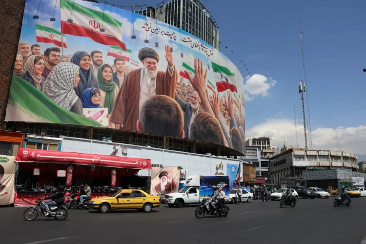 Iranians drive past a huge billboard carrying a picture of the late Iranian Supreme Leader Ayatollah Ali Khamenei in Tehran, Iran, 28 April 2026