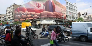 Iranians drive past a large billboard of Iranian Supreme Leader Ayatollah Mojtaba Khamenei on a street in Tehran, Iran, 20 April 2026