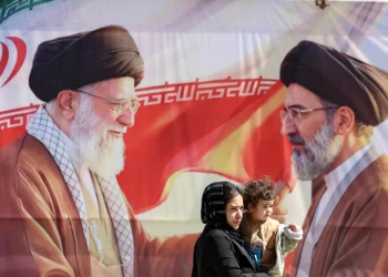 Iranians pass a billboard depicting late Iranian supreme leaders in Tehran, Iran, 23 April 2026
