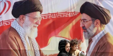 Iranians pass a billboard depicting late Iranian supreme leaders in Tehran, Iran, 23 April 2026