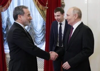 Russia's President Vladimir Putin (R) and Iran's Foreign Minister Abbas Araghchi