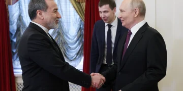 Russia's President Vladimir Putin (R) and Iran's Foreign Minister Abbas Araghchi