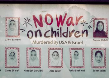 A poster with pictures of child war casualties on display on the wall of the Iranian consulate, in Shanghai, China, 30 April 2026