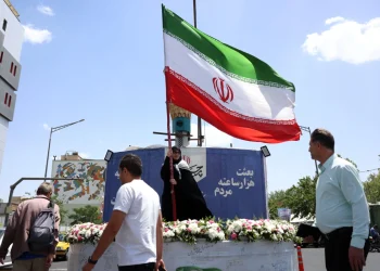 a-woman-holds-iran-s-national-flag-in-a-street-in-tehran-iran-17-may-2026-1200x800.webp
