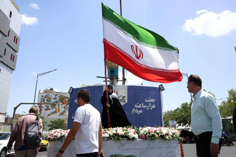 a-woman-holds-iran-s-national-flag-in-a-street-in-tehran-iran-17-may-2026-1200x800.webp