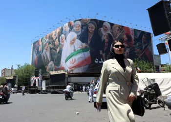 a-woman-walks-next-to-a-huge-billboard-in-a-street-in-tehran-iran-25-may-2026-1200x800.webp