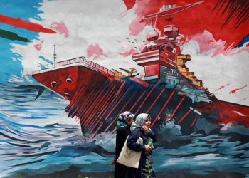 iranians-walk-next-to-an-anti-us-mural-in-a-street-in-tehran-iran-04-may-202-1200x800.webp