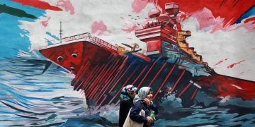 iranians-walk-next-to-an-anti-us-mural-in-a-street-in-tehran-iran-04-may-202-1200x800.webp