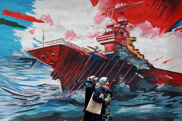 iranians-walk-next-to-an-anti-us-mural-in-a-street-in-tehran-iran-04-may-202-1200x800.webp