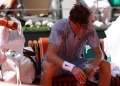 Jannik Sinner of Italy reacts to the heat during a break during his Men's 2nd round match against Juan Manuel Cerundolo