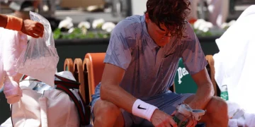 Jannik Sinner of Italy reacts to the heat during a break during his Men's 2nd round match against Juan Manuel Cerundolo