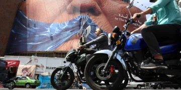 People drive near a huge anti-US billboard with photo depicting US President Donald Trump at Valiasr square in Tehran, Iran, 06 May 2026
