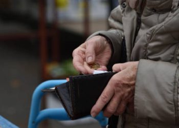 uomo seduto con portafoglio in mano