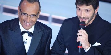 Stefano De Martino e Carlo Conti sorridenti sul palco del Festival di Sanremo