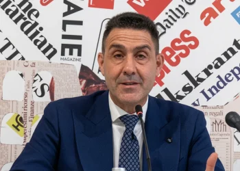 Roberto Vannacci in conferenza stampa con sfondo di ritagli di giornale