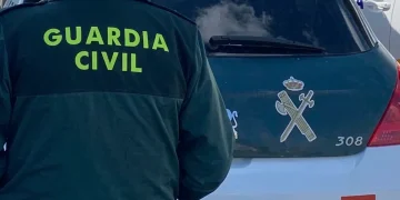 Agente Guardia Civil davanti auto polizia in Spagna