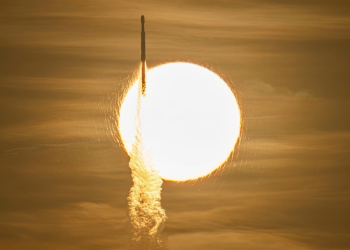 Razzo si lancia con scia luminosa davanti a un corpo celeste brillante. Il telescopio spaziale Roman lanciato da Cape Canaveral: parte la missione su materia ed energia oscura