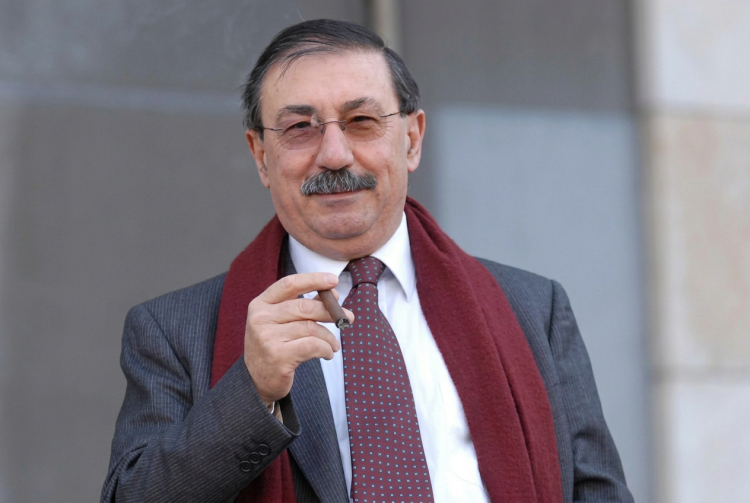 Fabio Mussi sorride con occhiali e sigaro, sciarpa bordeaux. È morto Fabio Mussi, ex ministro e storico esponente della sinistra